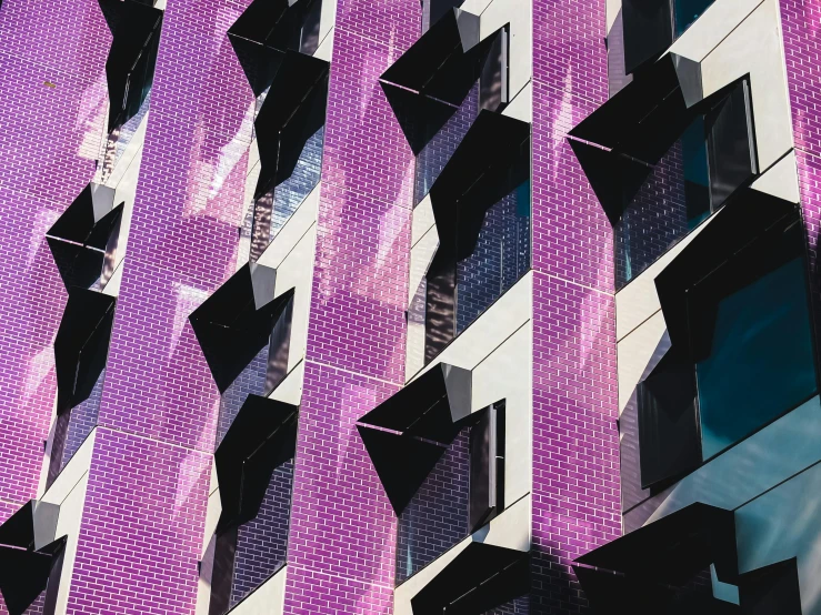 a close up of a building with many windows, by Lee Loughridge, pexels contest winner, modernism, purple ribbons, perforated metal, melbourne, magenta and gray