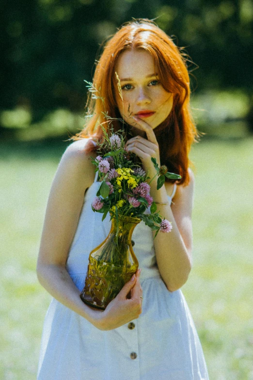 a woman in a white dress holding a vase of flowers, pexels contest winner, a redheaded young woman, meadow, julia sarda, teen girl