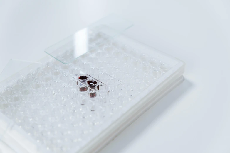 a close up of a cell phone on a table, plasticien, 4 0 0 0 samples, brown holes, set against a white background, sterile minimalistic room