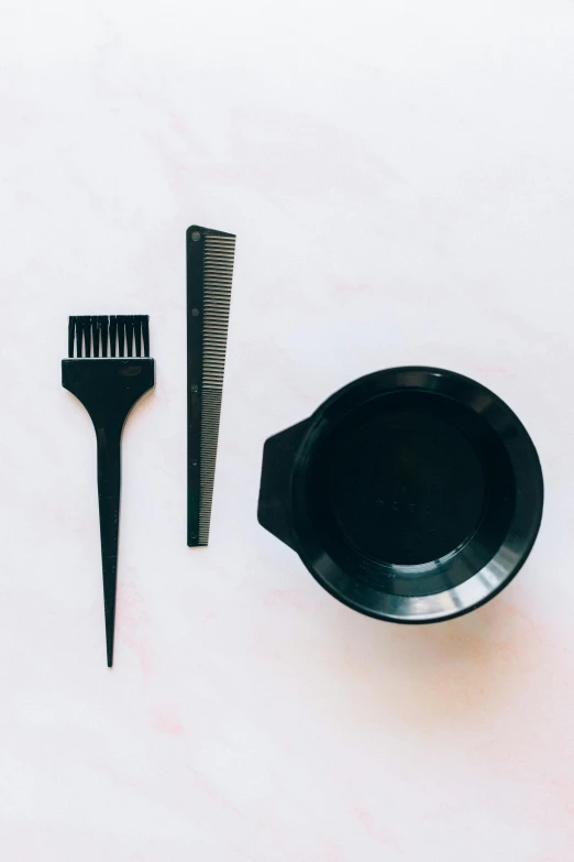 a hair brush, comb and bowl on a table, a gouache, trending on pexels, gradient from green to black, bowl haircut, disassembled, made of smooth black goo