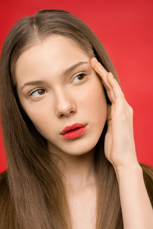 a beautiful young woman posing in front of a red background, trending on pexels, exhausted face close up, promo image, wide forehead, pale complexion