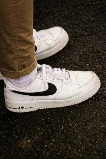 a person wearing brown pants and white sneakers, trending on pexels, hyperrealism, nike logo, us airforce, white and black, seeds