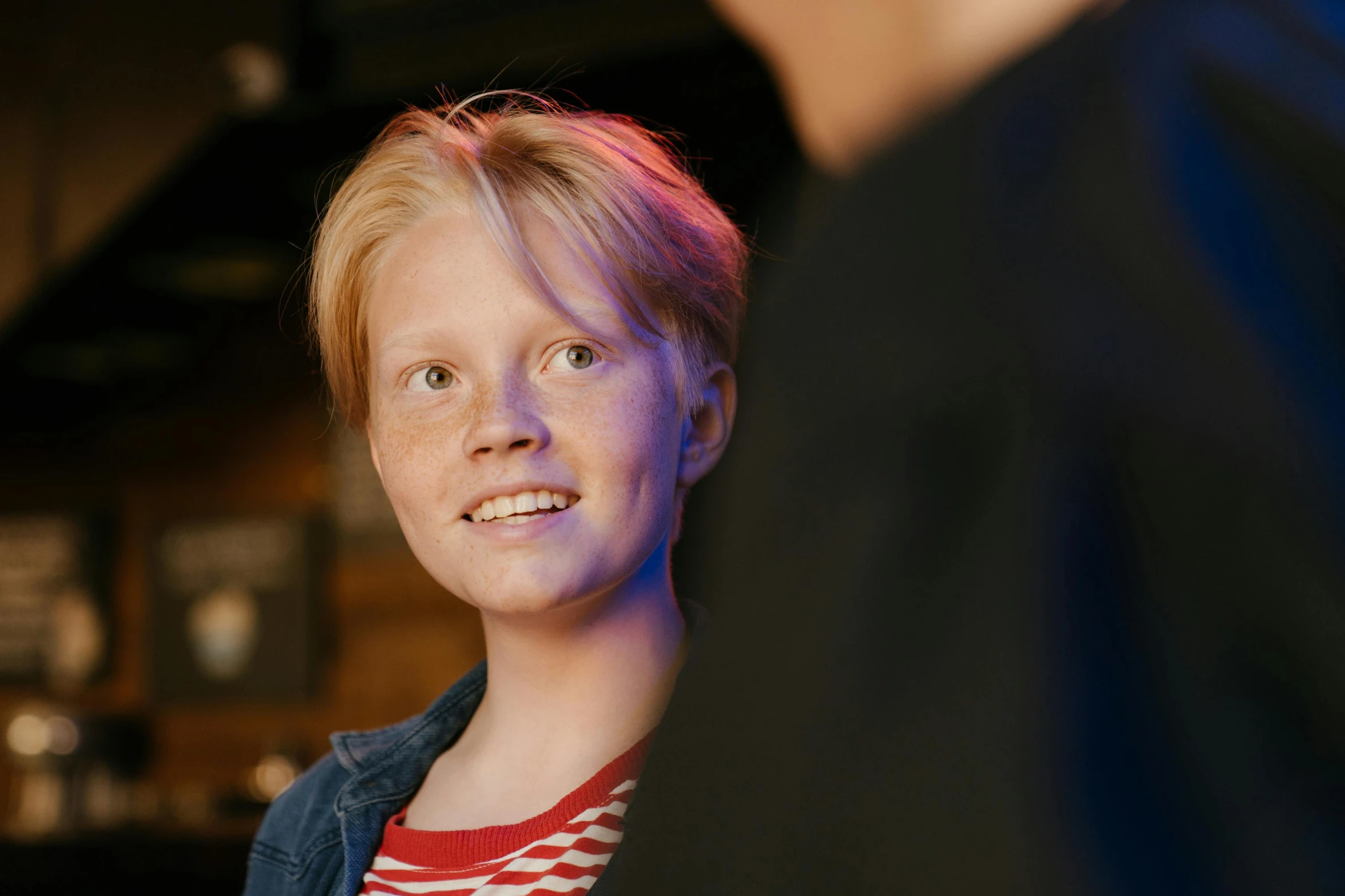 a close up of a person holding a nintendo wii controller, an album cover, by Emma Andijewska, pexels contest winner, happening, greta thunberg smiling, at a bar, red haired teen boy, 15081959 21121991 01012000 4k