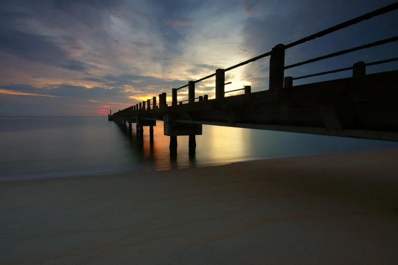 a pier stretching out into the ocean at sunset, by Peter Churcher, 8k fine art photography, medium format, viral image