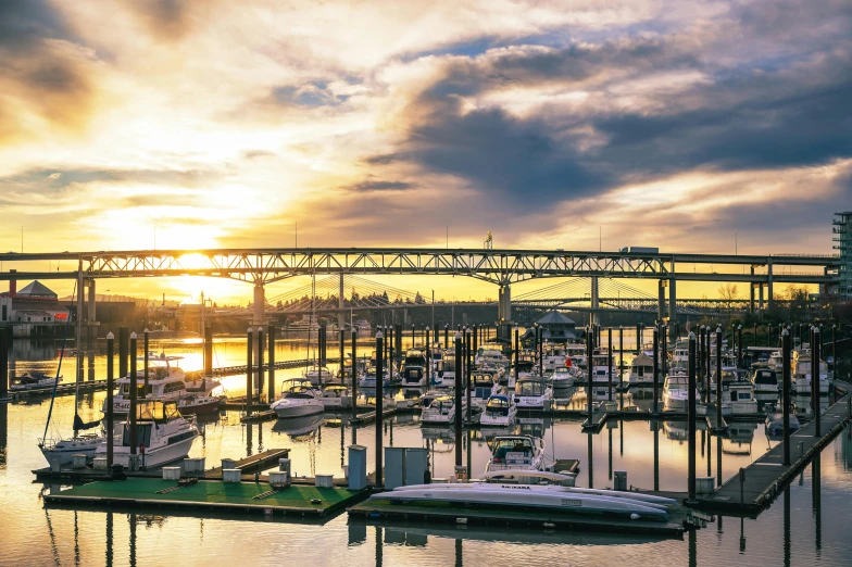 a harbor filled with lots of boats under a bridge, by Carey Morris, pexels contest winner, renaissance, ballard, golden hour photo, thumbnail, wide high angle view