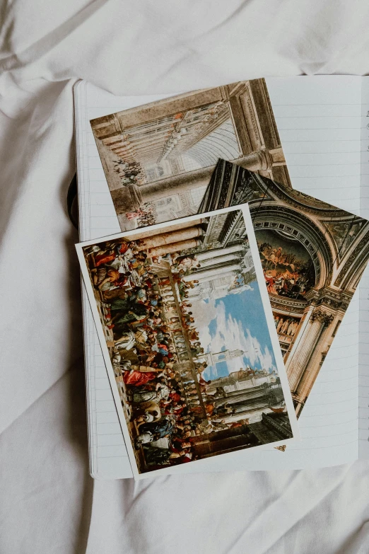 an open book sitting on top of a bed, a polaroid photo, inspired by Louis Le Nain, pexels contest winner, neoclassicism, architectural painting, pair of keycards on table, holding notebook, religious painting