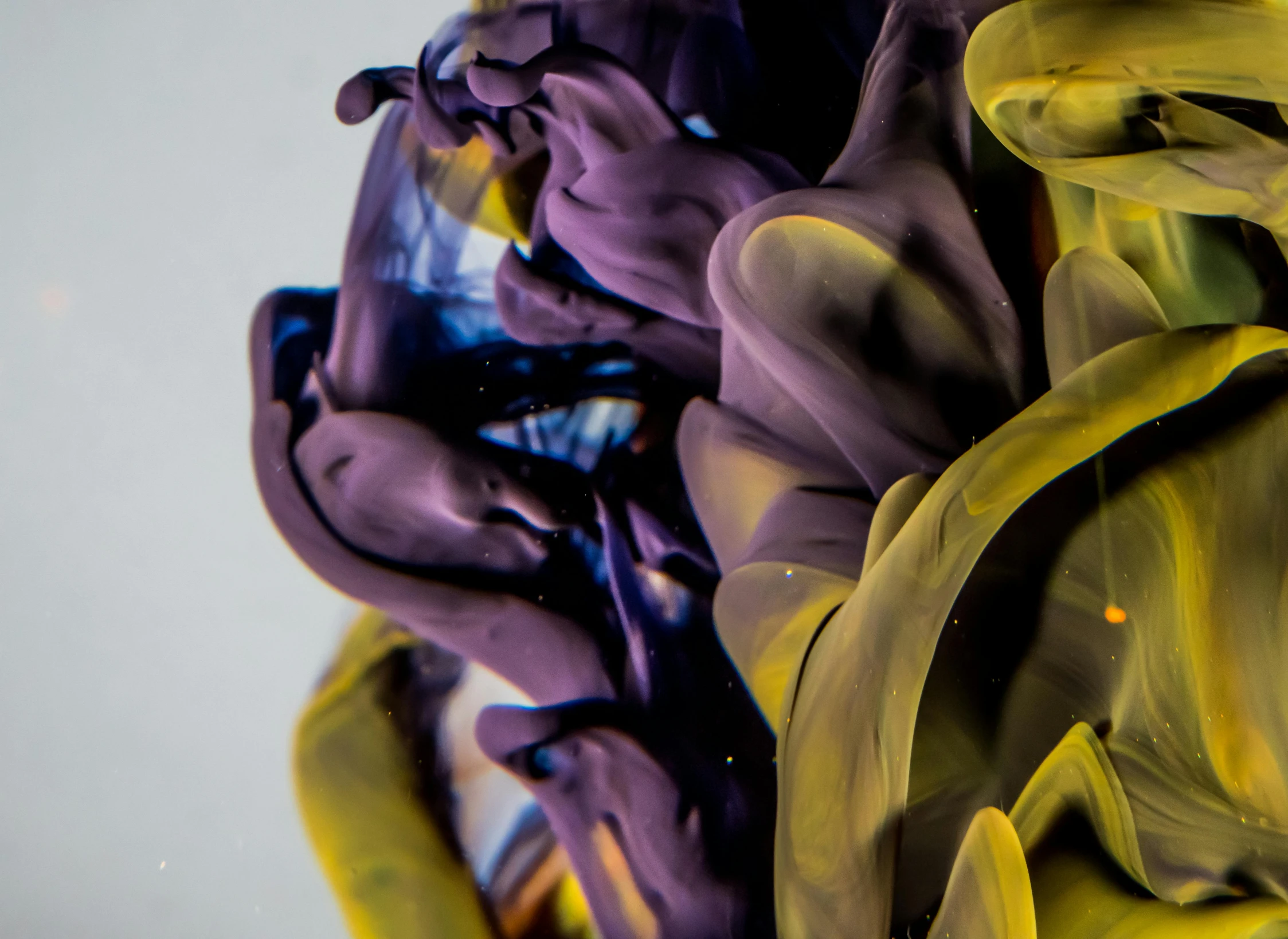 a close up of a person holding a cell phone, an abstract sculpture, inspired by Alberto Seveso, unsplash, yellow purple, abstract liquid, taken with sony alpha 9, underwater ink