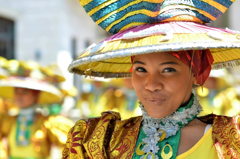 a close up of a person wearing a hat, inspired by Camille-Pierre Pambu Bodo, pexels contest winner, renaissance, parade, group photo, colorful uniforms, lady using yellow dress