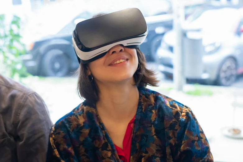 a woman wearing a virtual reality headset sitting next to a man, unsplash, happening, closeup photograph, avatar image, enamel, casually dressed