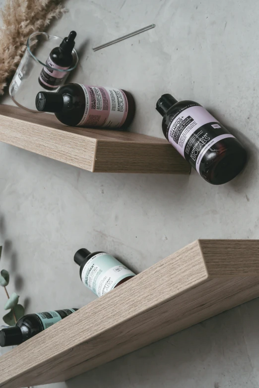 a couple of wooden shelves sitting on top of a wall, by Yerkaland, photoshoot for skincare brand, purple liquid, dynamic angled shot, bedhead