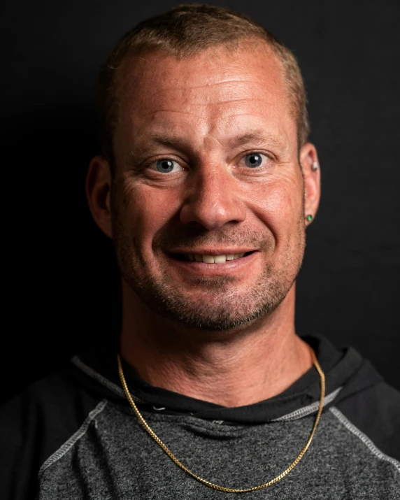 a man standing in front of a black background, by Arnie Swekel, very muscly, smiling male, mark van haitsma, leaked image