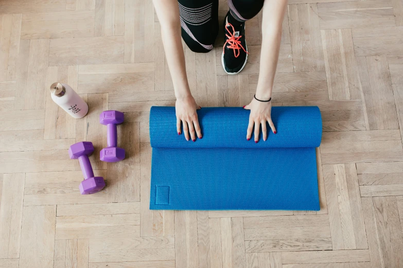 a woman standing on top of a blue yoga mat, pexels contest winner, lifting weights, flatlay, 15081959 21121991 01012000 4k, glowing blue interior components