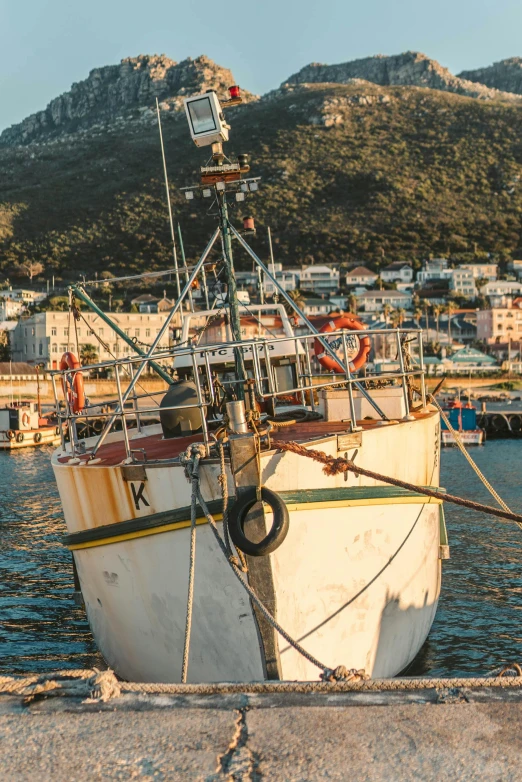 a boat that is sitting in the water, fishing town, south african coast, looking smug, sun lit