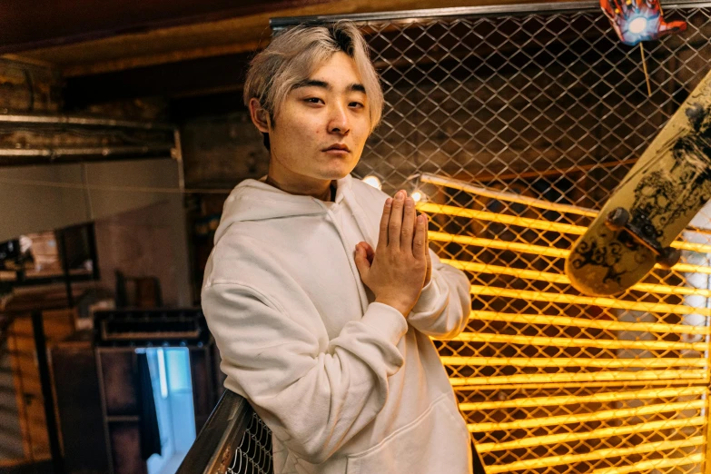 a person standing in front of a giraffe, an album cover, inspired by Zhu Da, unsplash, neo-dada, wearing silver hair, standing in a buddhist temple, inside of a tokyo garage, he is casting a lighting spell