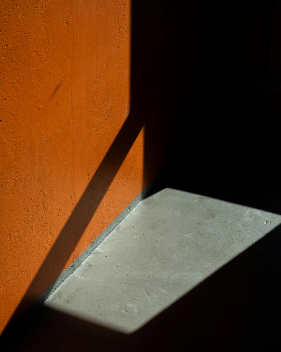 a shadow of a window on a wall, by Elsa Bleda, unsplash, postminimalism, orange grey white, polished concrete, paul barson, taken in the late 2010s