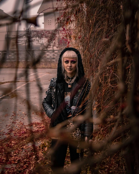 a woman that is standing in the grass, a character portrait, pexels contest winner, antipodeans, dressed in punk clothing, in a tree, wearing studded leather, standing in a city street