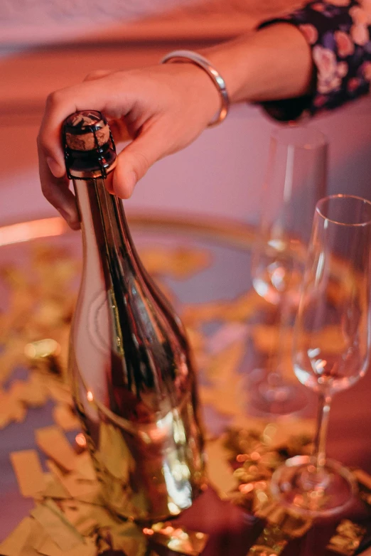 a person opening a bottle of wine on a table, bubbly, golden detailing, thumbnail, event photography