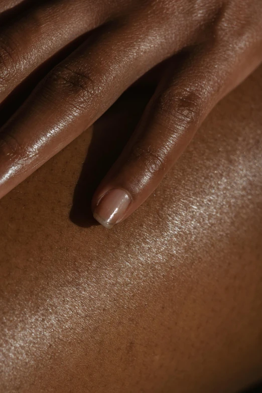 a close up of a person getting a massage, by Alexander Mann, trending on pexels, hyperrealism, ebony skin, pale smooth, close-up of thin soft hand, sunbathed skin