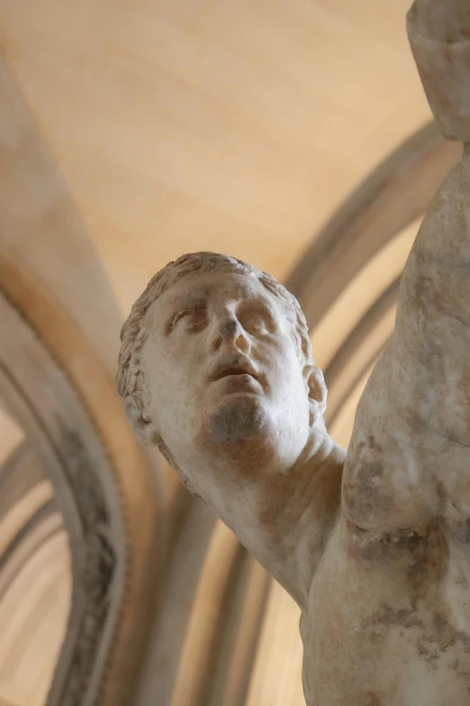 a close up of a statue in a building, cathedral ceiling, lecherous pose, high forehead, over his shoulder