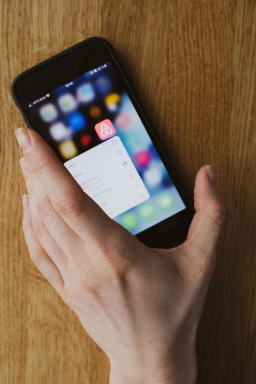 a close up of a person holding a cell phone, a picture, ios app icon, sleek hands, square, in 2 0 1 5