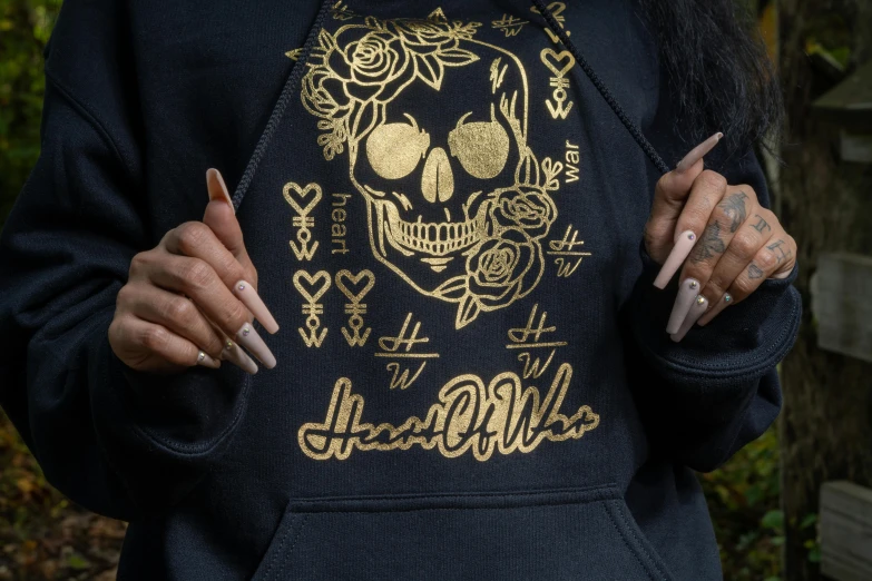 a close up of a person wearing a hoodie, inspired by Hedi Xandt, graffiti, gold skulls, hand drawn svg, gothic harts, flowers and gold