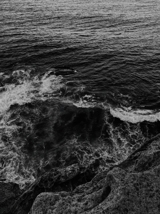 a black and white photo of the ocean, a black and white photo, by Christen Dalsgaard, unsplash, lit from above, darkwave goth aesthetic, whirlpool, jovana rikalo