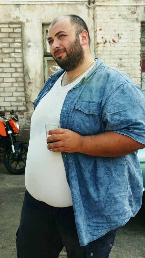 a man standing in a parking lot next to a motorcycle, pexels contest winner, hyperrealism, chris evans with a beer belly, obese ), wearing a light shirt, 15081959 21121991 01012000 4k