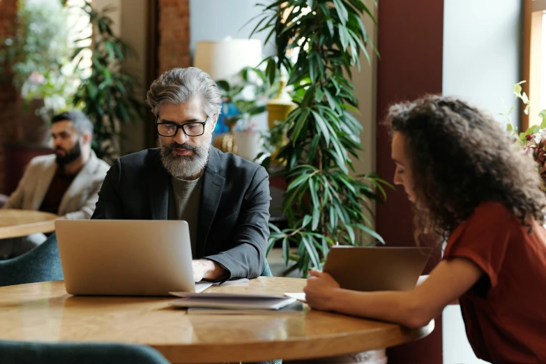 a man and a woman sitting at a table with a laptop, pexels contest winner, stephen conroy, in meeting together, avatar image, high quality picture