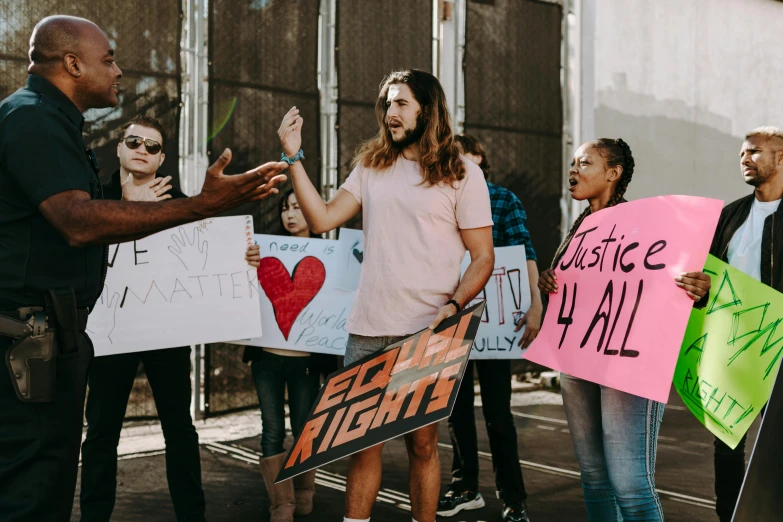 a group of people holding signs in front of a building, trending on pexels, sots art, justice, concert photo, a person standing in front of a, fights