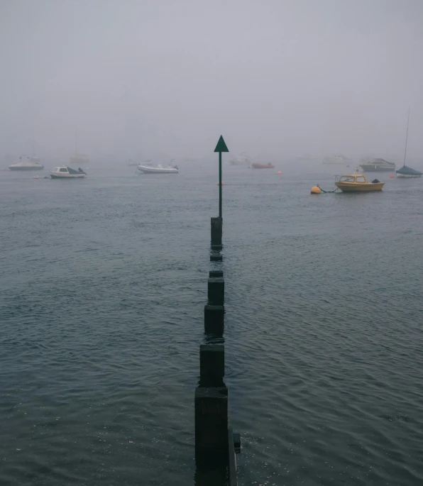 a group of boats floating on top of a body of water, an album cover, by Tobias Stimmer, pexels contest winner, postminimalism, foggy rainy day, harbor, manly, 2 5 6 x 2 5 6 pixels