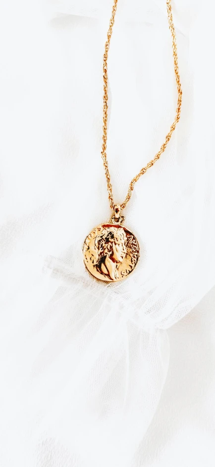 a gold necklace with a coin on it, a portrait, by Julia Pishtar, trending on pexels, baroque, thumbnail, icon, flowy, 15081959 21121991 01012000 4k