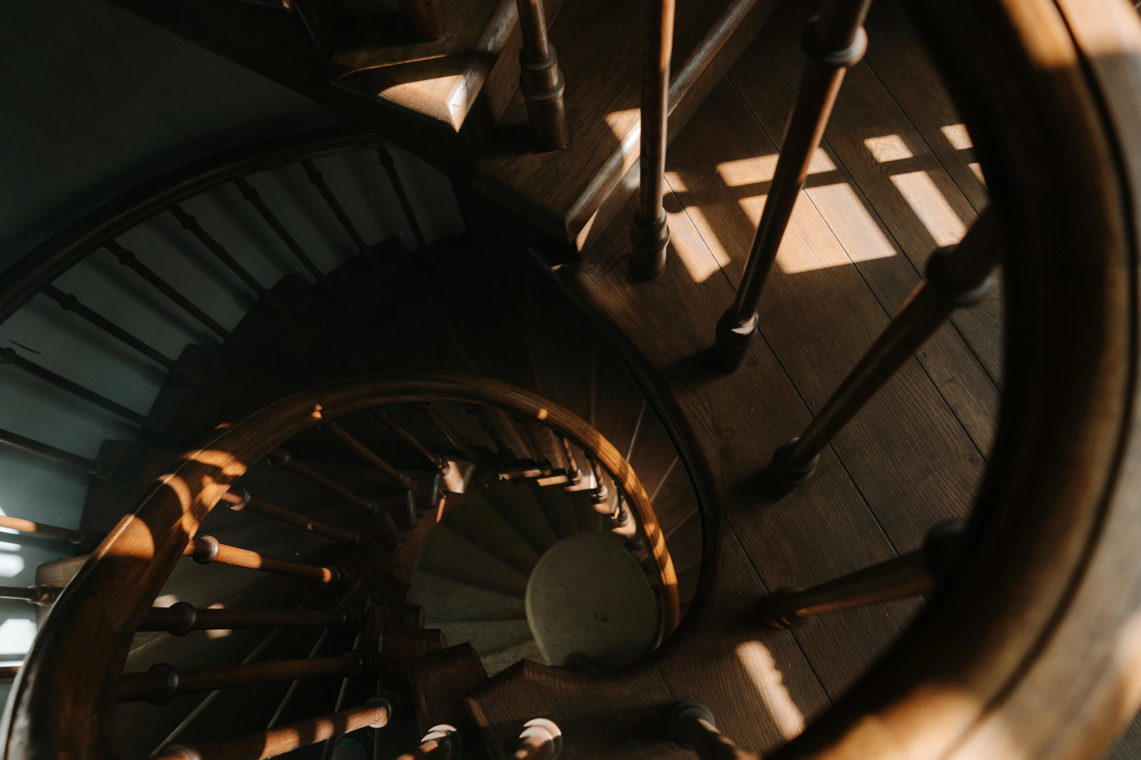 a close up of a spiral staircase in a building, an album cover, pexels contest winner, light and space, brown, glowing light and shadow, interior of a victorian house, 1 4 9 3