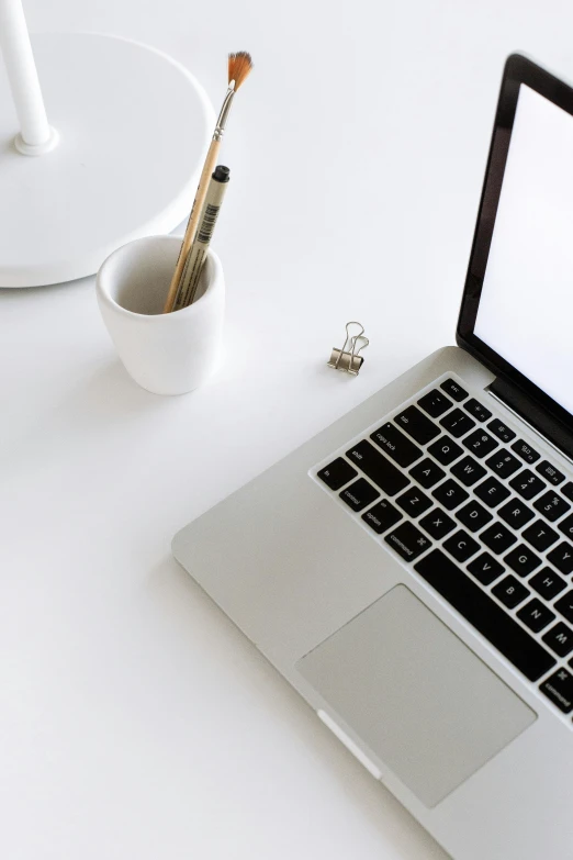 a laptop computer sitting on top of a white desk, by Carey Morris, trending on unsplash, clean details, vanilla, carefully crafted, high quality photo