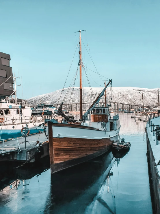 a number of boats in a body of water, by Terese Nielsen, pexels contest winner, modernism, reykjavik, in retro colors, docked at harbor, portrait photo