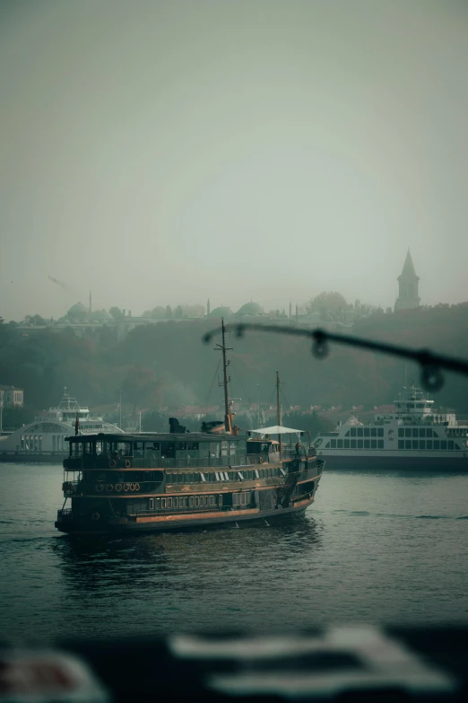 a boat that is sitting in the water, a detailed matte painting, inspired by Elsa Bleda, pexels contest winner, tonalism, fallout style istanbul, moist foggy, eye level shot, grainy quality