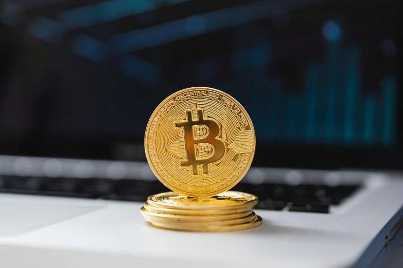 a stack of gold bitcoins sitting on top of a laptop, trending on pexels, avatar image, thumbnail, instagram post, ad image