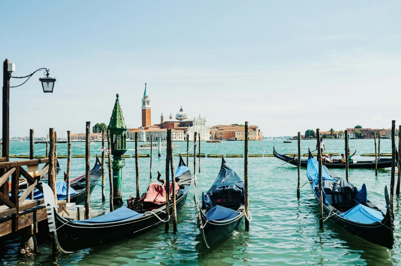 a number of boats in a body of water, a photo, inspired by Quirizio di Giovanni da Murano, pexels contest winner, gondolas, a photo of a lake on a sunny day, photo for vogue, thumbnail