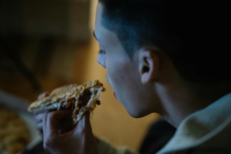 a man is eating a slice of pizza, by Adam Marczyński, pexels contest winner, realism, still from stranger things movie, soft light from the side, profile picture 1024px, boys