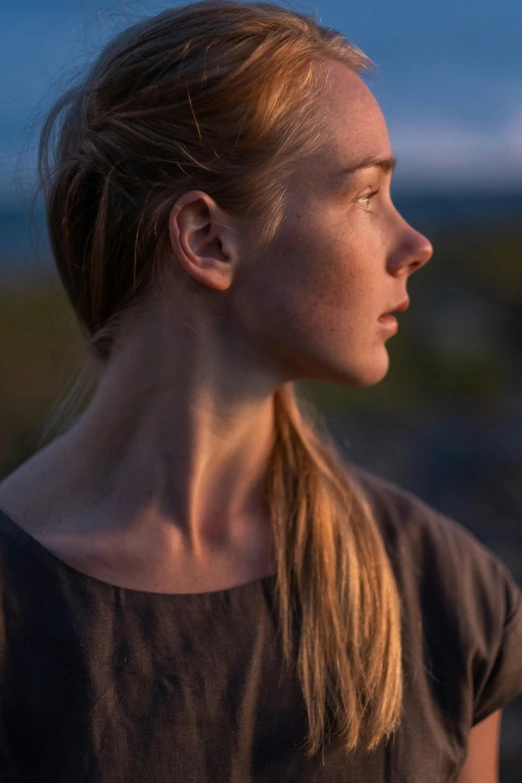 a woman standing in front of a body of water, a character portrait, by Anna Boch, unsplash, digital art, evening sunlight, viking face in profile, cinestill colour cinematography, a full portrait of nordic female