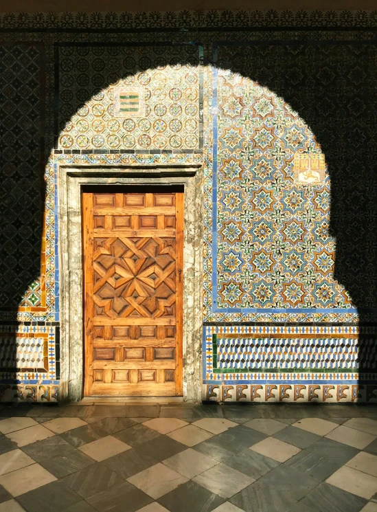 a large wooden door sitting inside of a building, a mosaic, inspired by Luis Paret y Alcazar, pexels contest winner, islamic, winter sun, 🚿🗝📝, tomb