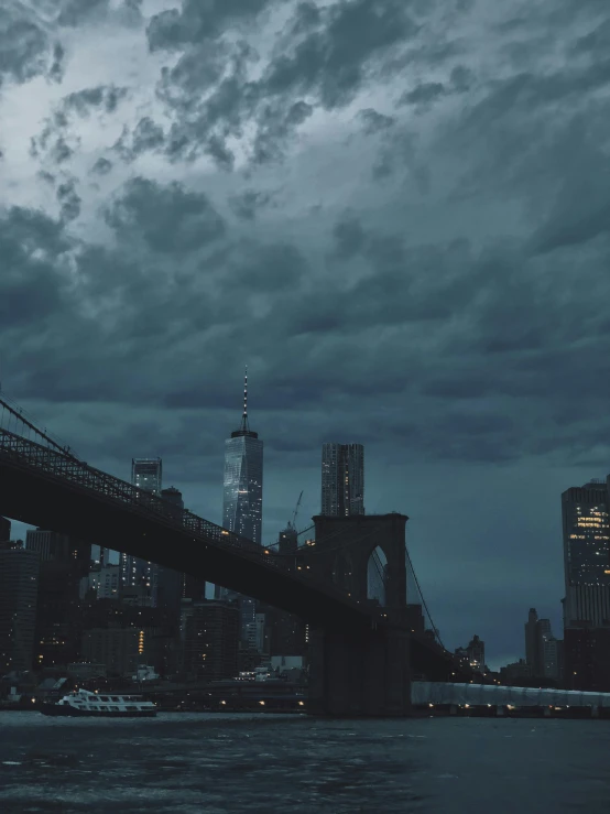 a bridge over a body of water under a cloudy sky, a matte painting, inspired by Elsa Bleda, pexels contest winner, attacking nyc, thunderstorm dark night sky, ☁🌪🌙👩🏾, snapchat photo