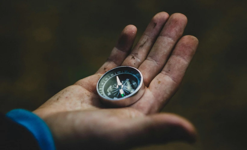 a person holding a compass in their hand, pexels contest winner, avatar image, mini model, open palm, paul barson