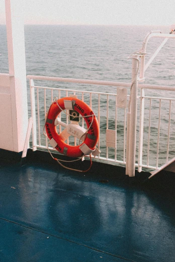 a life preserver on the deck of a boat, a picture, by Elsa Bleda, unsplash, romanticism, low quality photo, 90s photo, multiple stories, tourist photo
