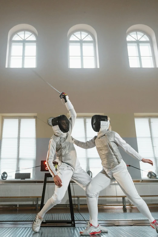 a couple of men standing next to each other on a court, pexels contest winner, renaissance, fencing, man in silver space suit, practising her sword staces, australia