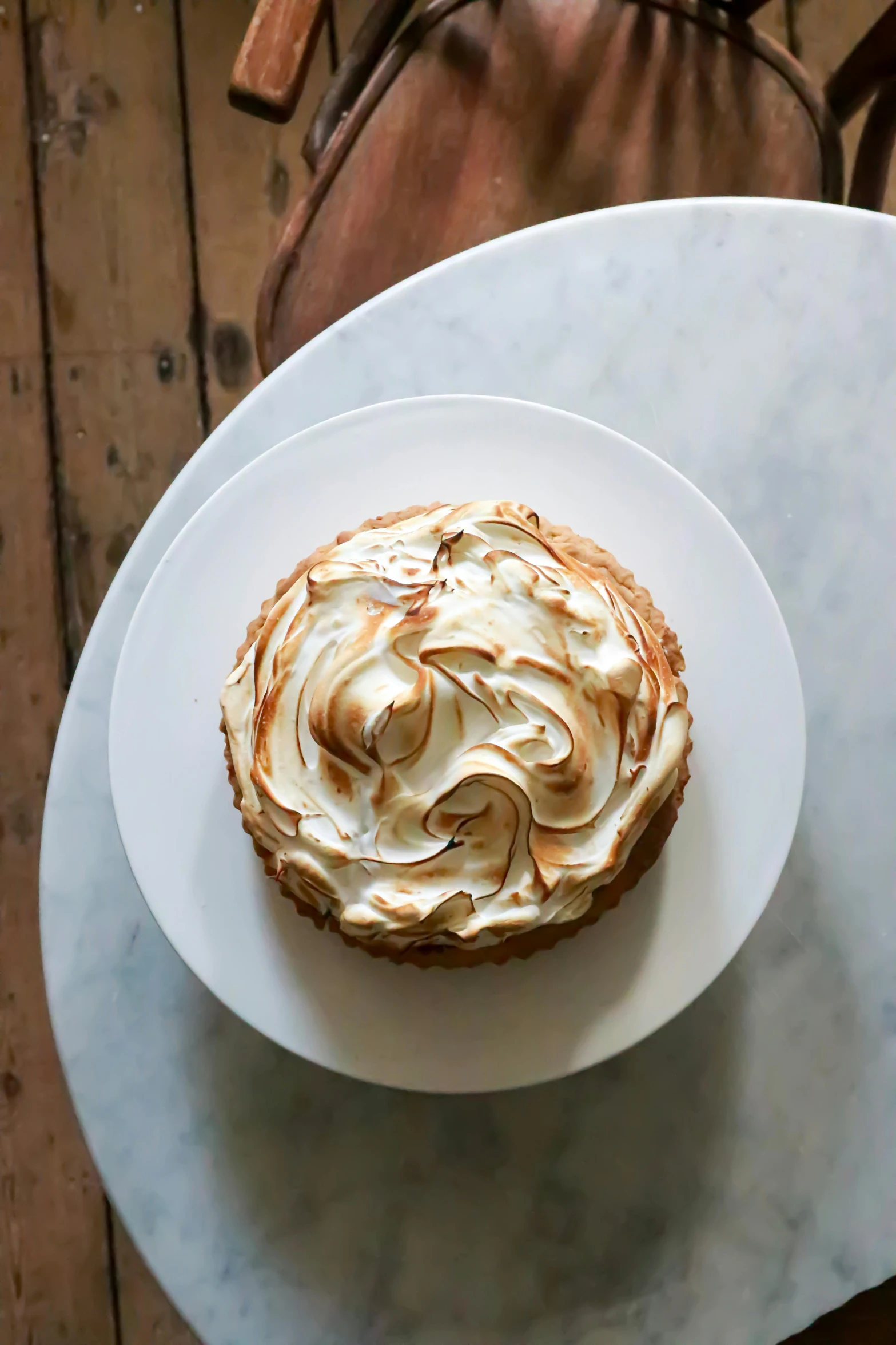 a white plate topped with a pastry on top of a table, by Emma Lampert Cooper, marshmallow, cake, goop, high angle