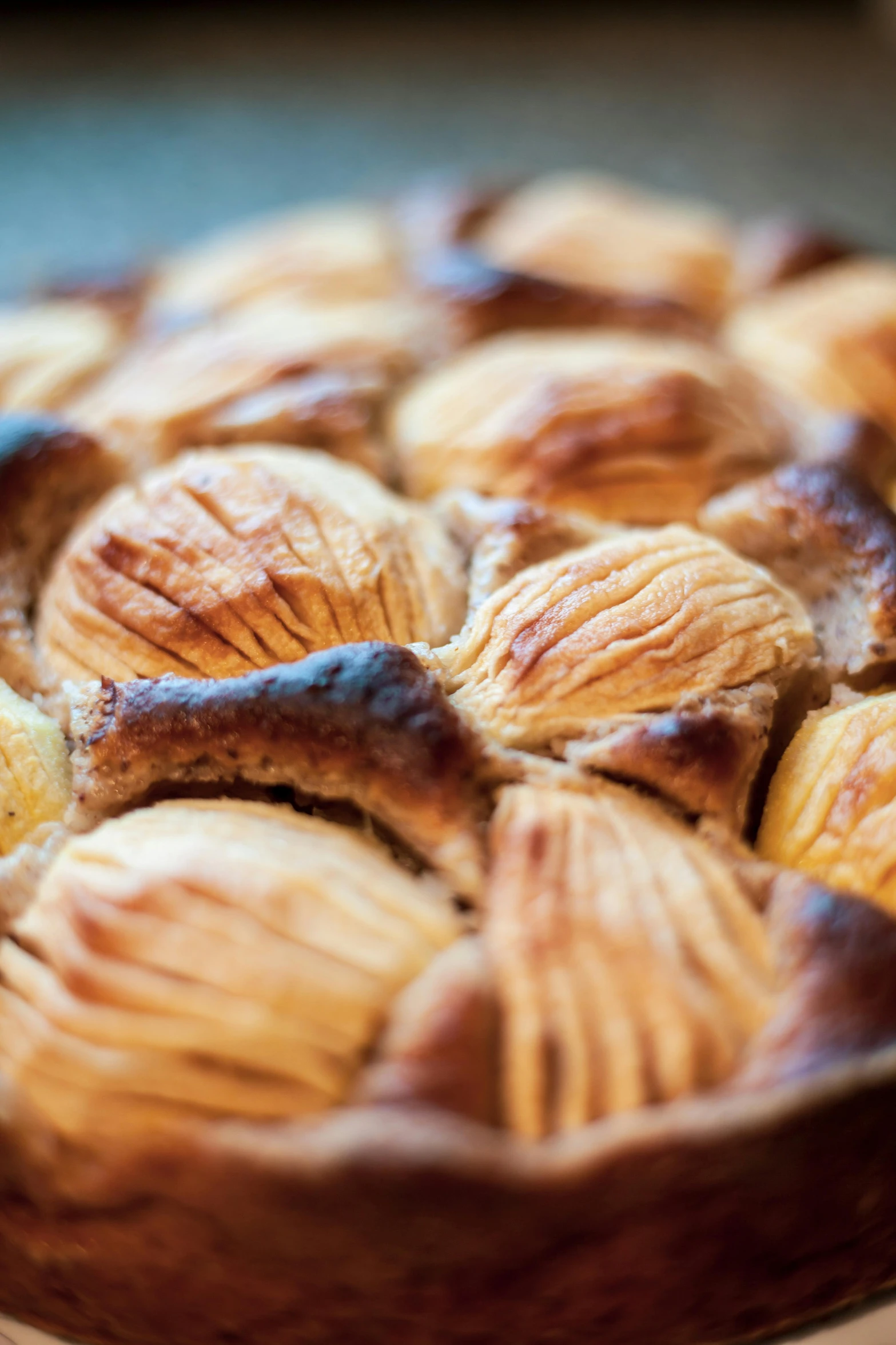 a pie sitting on top of a wooden table, intricate wrinkles, pastries, slide show, yann blomquist