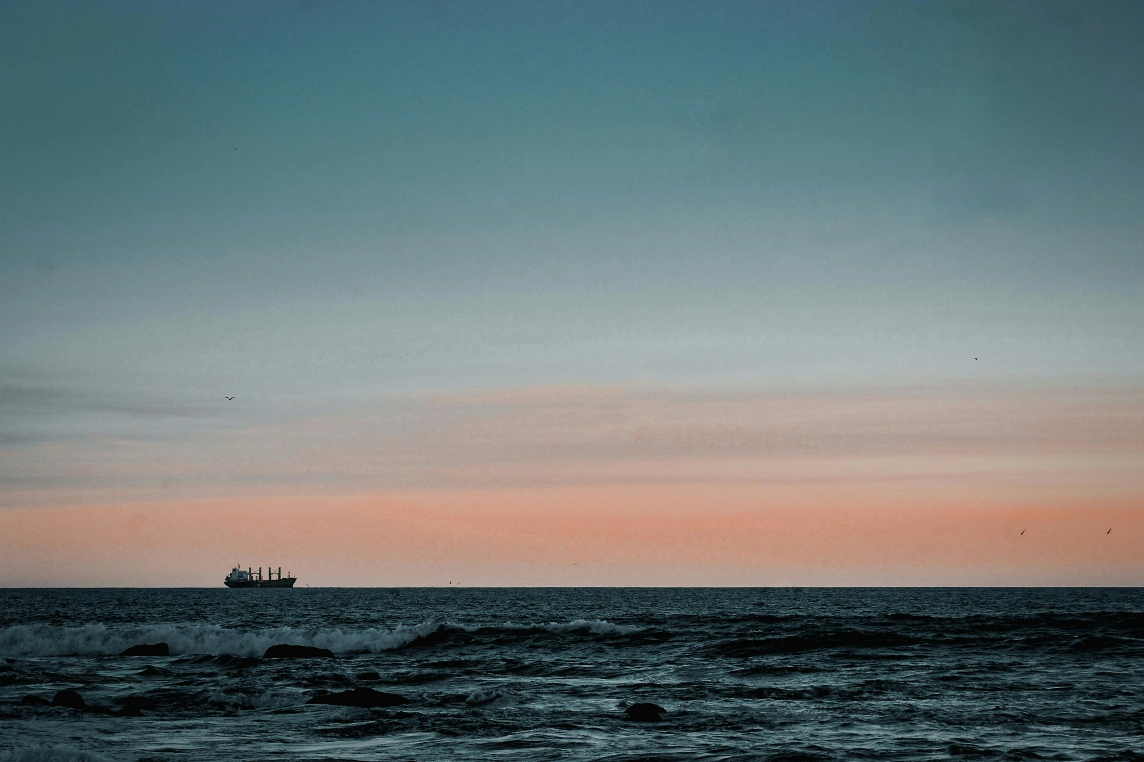 a boat floating on top of a body of water, inspired by Elsa Bleda, pexels contest winner, minimalism, shipfleet on the horizon, evening sky, container ship, oil dereks on horizon