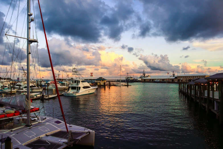 a harbor filled with lots of boats under a cloudy sky, a portrait, by Carey Morris, pexels contest winner, sunset view, profile image, bahamas, annie liebowitz