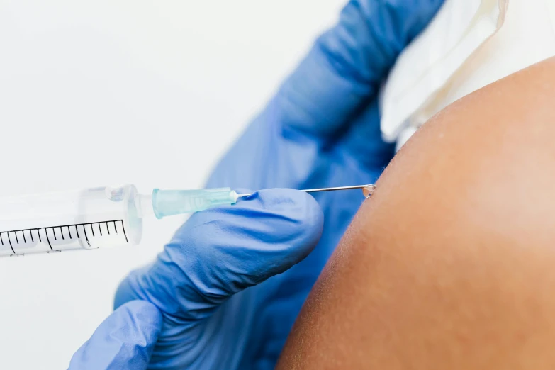 a close up of a person getting an injection, an album cover, by Gavin Hamilton, shutterstock, renaissance, photograph credit: ap, up to the elbow, blue, bumps