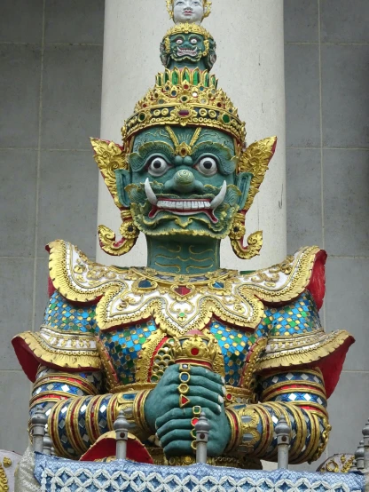 a close up of a statue in front of a building, in front of a temple